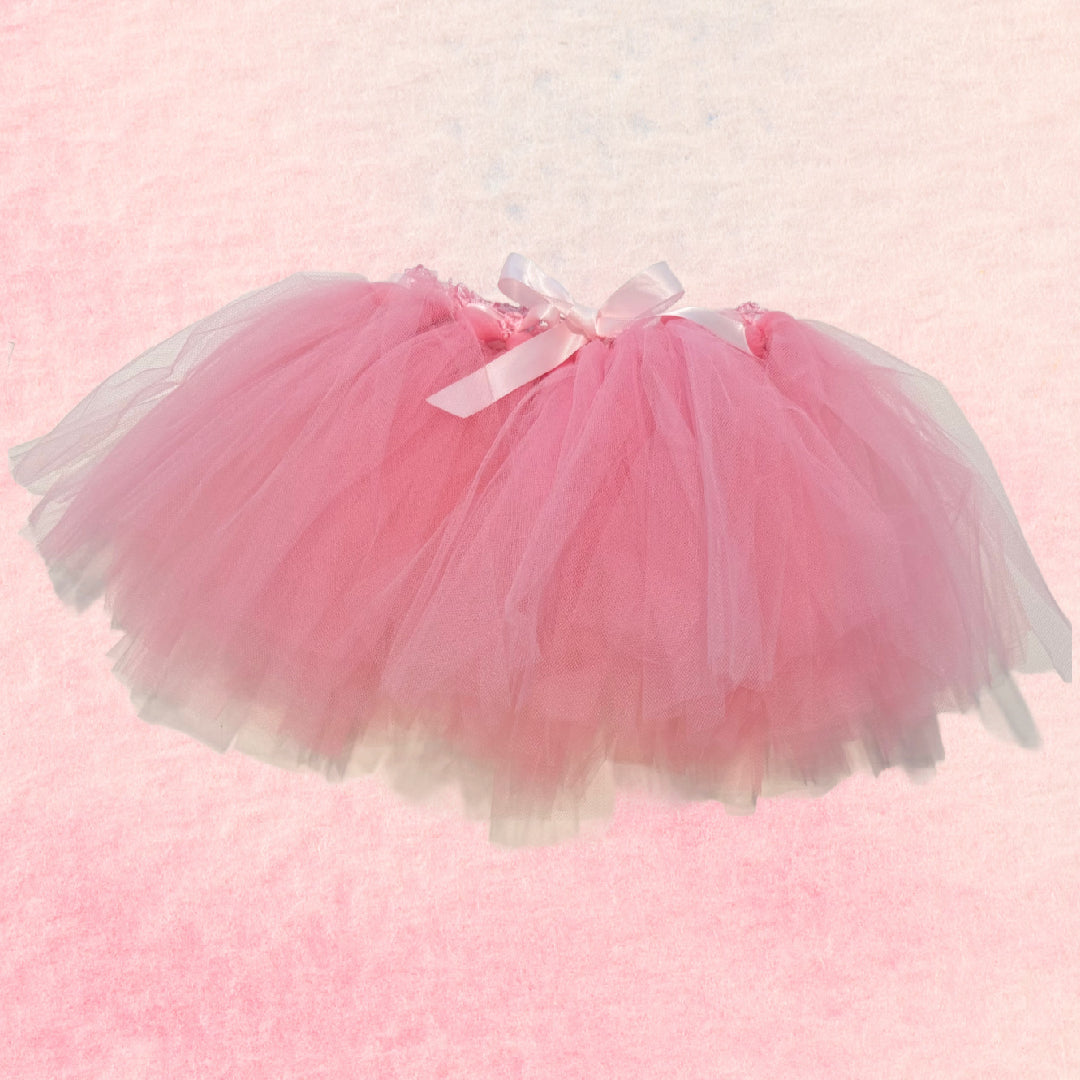 Pink tutu skirt with a bow on a pink background